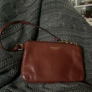 Coach Wristlet slightly used zip close with pocket slips inside.